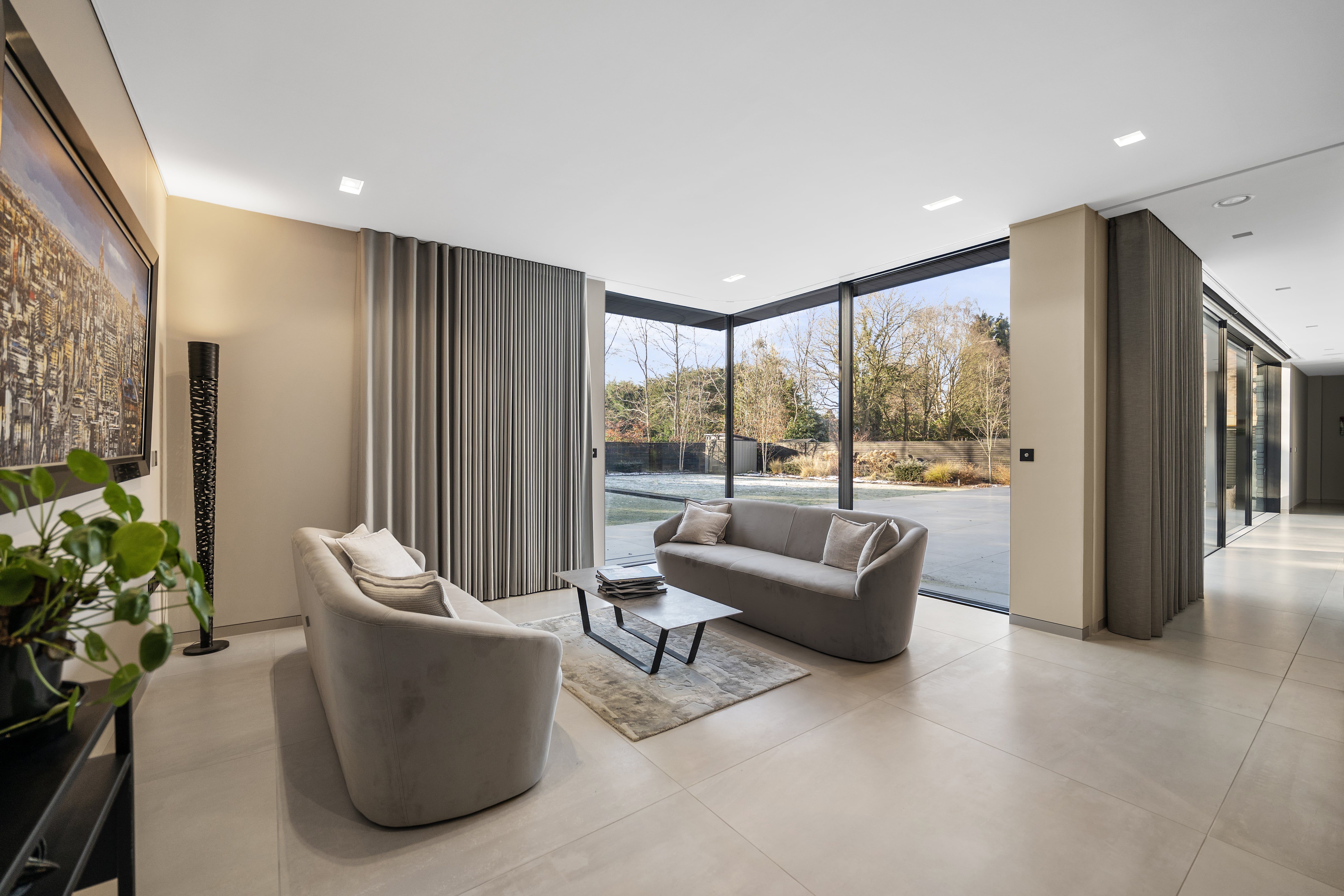 Open-plan living room with floor-to-ceiling windows in a luxury home