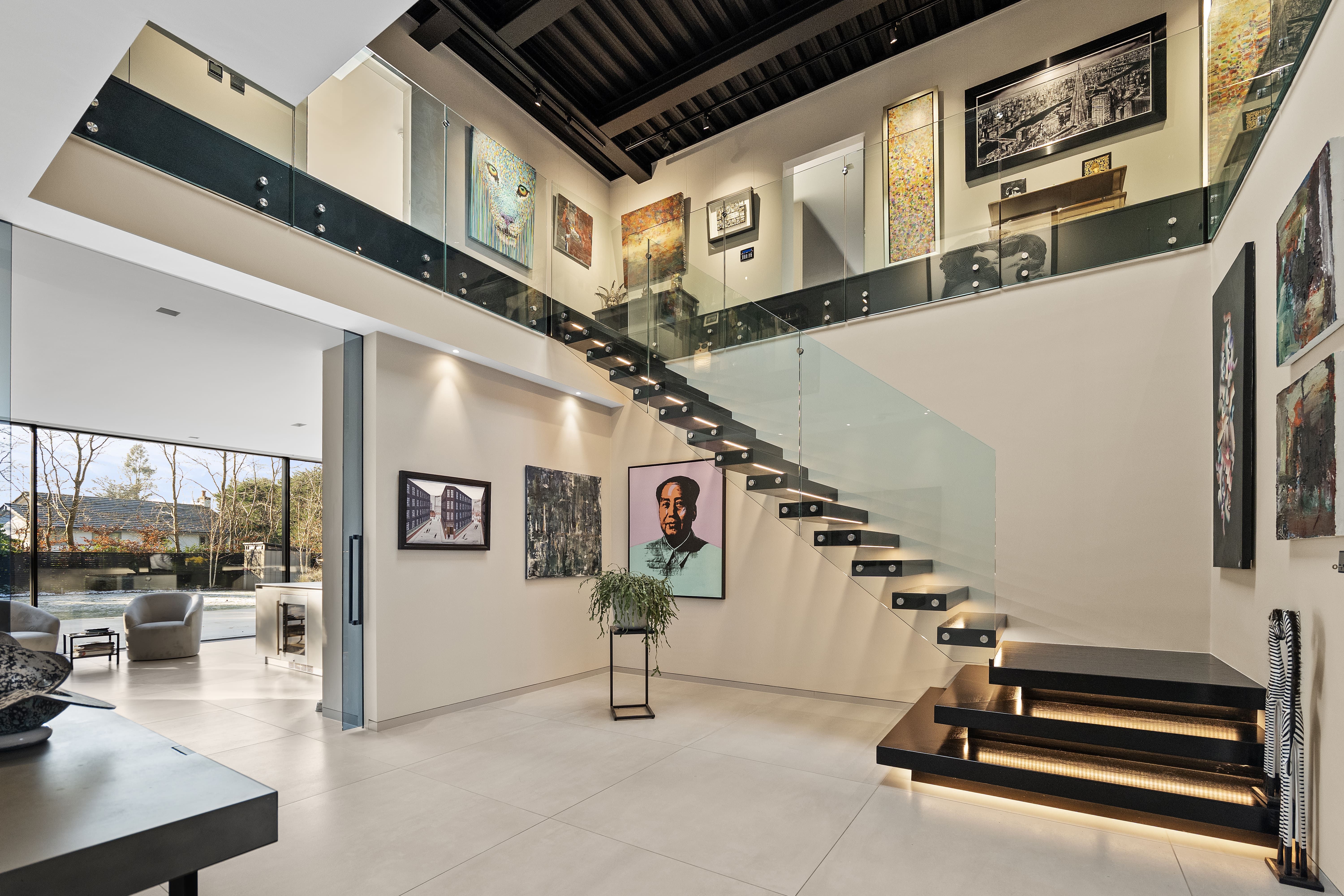 Double-height entrance hall with a floating cantilever staircase