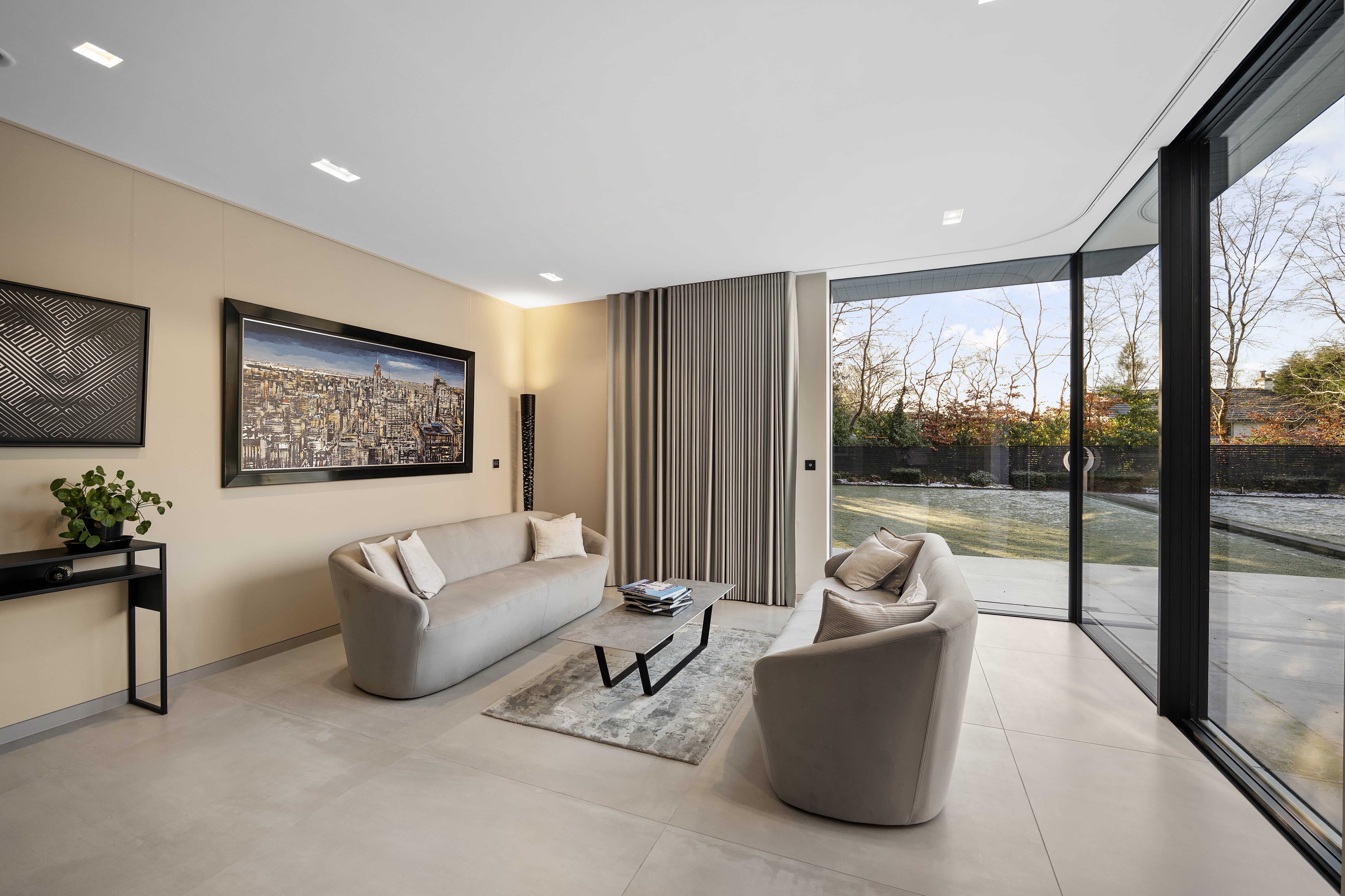 Sitting room opening to the garden through full-height sliding doors